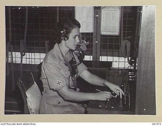 BOUGAINVILLE, 1945-04-19. VFX121111 PRIVATE KATHLEEN MARGARET (PEGGY) THOMSON, AUSTRALIAN ARMY MEDICAL WOMEN'S SERVICE, WORKING AT THE HOSPITAL EXCHANGE, 2/1 GENERAL HOSPITAL