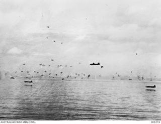 GUADALCANAL, SOLOMON ISLANDS. 1942-08-08. FOUR JAPANESE NAVAL AIR FORCE MITSUBISHI G4M (BETTY) BOMBERS COME IN VERY LOW THROUGH HEAVY ANTI AIRCRAFT FIRE TO ATTACK US TRANSPORTS (NOT VISIBLE). TWO ..