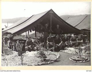WEWAK POINT, NEW GUINEA. 1945-10-02. A SMARTNESS OF LINES COMPETITION WAS HELD AT 2/3 MACHINE-GUN BATTALION AND TROOPS WERE GIVEN A WEEK TO DECORATE THEIR LINES. THE COMPETITION WAS WON BY THIS 10 ..