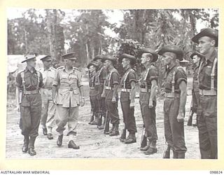 TOROKINA, BOUGAINVILLE. 1945-06-08. LIEUTENANT GENERAL V.A.H. STURDEE, GENERAL OFFICER COMMANDING FIRST ARMY, ACCOMPANIED BY LIEUTENANT G.R.H. GLANVILLE, OFFICER COMMANDING D COMPANY, 2/1 GUARD ..