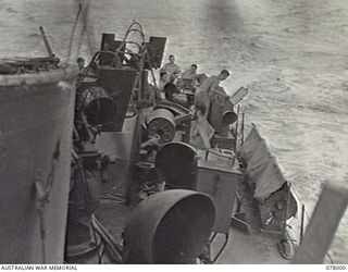 AT SEA. 1944-12-27. LOOKING TOWARDS THE STERN OF THE RAN VESSEL ML802 AS SHE PROCEEDS TOWARDS SAMPUN. VX27 MAJOR GENERAL A. H. RAMSAY, CBE, DSO, GENERAL OFFICER COMMANDING, 5TH DIVISION (1) AND ..