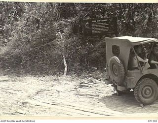 FINSCHHAFEN AREA, NEW GUINEA, 1944-03-17. ONE OF MANY BATTLE SIGNS IN THE FINSCHHAFEN AREA, THIS SIGN AT "TURN OFF CORNER" INDICATES ACTIVITIES OF THE 2/23RD AND 2/48TH INFANTRY BATTALIONS