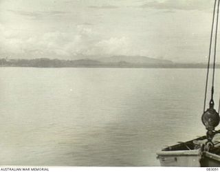AT SEA, NEW GUINEA. 1944-10-30. THE AITAPE AREA AS FIRST SEEN BY UNITS OF 6 DIVISION AND MEMBERS OF HQ 6 DIVISION AS THE AMERICAN TROOPSHIP MEXICO MOVES IN. THIS PHOTOGRAPH JOINS 83092 SHOWING ..