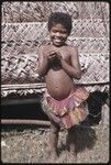 Smiling girl wearing a colorful banana-fiber skirt