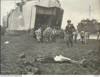 AITAPE AREA, NORTH EAST NEW GUINEA. C. 1944-04-22. GAPING JAWS OF A LANDING SHIP, TANK (LST) DISCHARGES HEAVY EQUIPMENT FOR RAAF WORKS, SURVEY AND SIGNALS UNITS DURING THE SUCCESSFUL ASSAULT ON ..