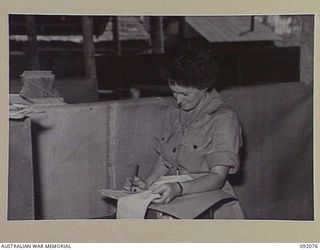 LAE, NEW GUINEA, 1945-05-20. PRIVATE E.Z. CARROLL, AWAS, FILING CLERK AT WORK AT HQ AUSTRALIAN ARMY CANTEENS SERVICE