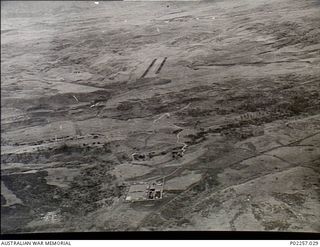 Garoka, New Guinea, 1945-11. Aerial view of the RAAF Aircrew Rest Camp (bottom) which is known as 'Lamana', meaning 'Eternal Springs', with the camp's airstrip (top). The rest camp, located in the ..