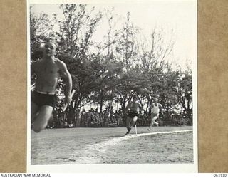 ELA BEACH, NEW GUINEA. 1944-01-01. THE 880 YARDS RELAY RACE IN PROGRESS AT THE GRAND SPORTS CARNIVAL