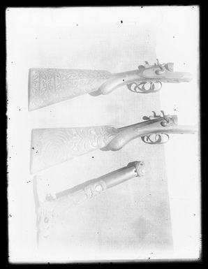 [Carved adze handle and two musket butt and stocks]