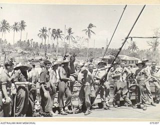 MADANG, NEW GUINEA. 1944-08-19. HAPPY MEMBERS OF THE 4TH INFANTRY BRIGADE ON THE DECK ON HMT "KATOOMBA" IMMEDIATELY PRIOR TO THEIR SAILING FOR THE MAINLAND. IDENTIFIED PERSONNEL ARE:- CORPORAL ..