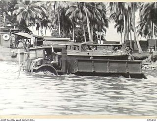 MILILAT, NEW GUINEA. 1944-08-22. A 3 TON FOUR WHEEL DRIVE CHEVROLET TRUCK BEING DRIVEN THROUGH DEEP WATER DURING TESTS OF A WATERPROOFING TECHNIQUE EVOLVED BY MEMBERS OF THE AUSTRALIAN ELECTRICAL ..