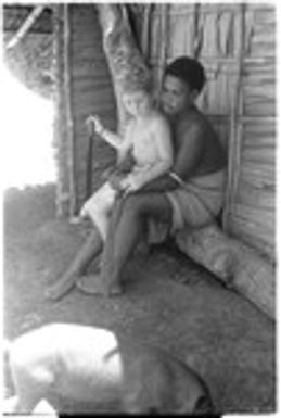 Lauren Keesing sitting on lap of a Kwaio child