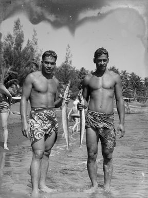 [Two Pacific Island men holding fish]