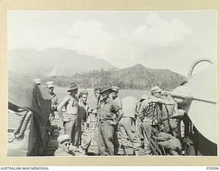 CAPE GLOUCESTER, NEW BRITAIN. 1944-10-14. MEMBERS OF THE 6TH LIGHT FIELD AMBULANCE AND AMERICAN TROOPS ON THE DECK OF THE DUTCH TROOPSHIP "SWEARTENHONDT" AS THE VESSEL DRAWS INTO BORGEN BAY TO ..