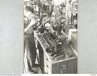 PORT MORESBY, NEW GUINEA. 1944-04-10. QX43235 CRAFTSMAN L. WILLIS REPAIRING BUSHES FOR AN IRON LUNG FROM A HOSPITAL AT THE 11TH ADVANCED WORKSHOP, AUSTRALIAN ELECTRICAL AND MECHANICAL ENGINEERS