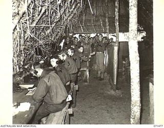 RAMU VALLEY, NEW GUINEA, 1944-03-26. THE SIGNAL OFFICE AT HEADQUARTERS, 15TH INFANTRY BRIGADE. IDENTIFIED PERSONNEL ARE: VX147319 SIGNALMAN K.C. BENNEL (1); V310552 SIGNALMAN V. GILBERT (2); ..