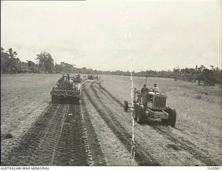 AITAPE, NORTH EAST NEW GUINEA. C. 1944-04. NO. 7 MOBILE WORKS SQUADRON RAAF GOES INTO ACTION WITH BULLDOZERS, TRACTORS, GRADERS, ROLLERS AND OTHER HEAVY EQUIPMENT WHICH WERE LANDED WITH THE ..