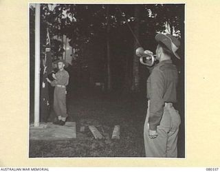 LAE, NEW GUINEA. 1944-07-27. THE SOUNDING OF "RETREAT" AT END OF DAY AT NO. 22 PLATOON, F COMPANY, 2/1ST GUARD REGIMENT. THIS PLATOON MAINTAINS GUARD DUTIES AT HEADQUARTERS NEW GUINEA FORCE