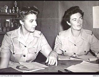 LAE, NEW GUINEA, 1946-01-09. CORPORAL J. REEVES AND CORPORAL D. M. O'CONNELL (2), CHECKING UNIT ORDERS AT THE DRY GOODS ISSUING POINT, AUSTRALIAN ARMY CANTEENS SERVICE BULK STORES