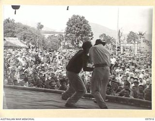 RABAUL, NEW BRITAIN. 1945-10-10. A SPECIAL PARADE AND CONCERT WAS HELD AT THE CAMP TO CELEBRATE THE 34TH ANNIVERSARY OF THE FOUNDING OF THE CHINESE REPUBLIC. SHOWN, A SCENE ON THE STAGE DURING THE ..