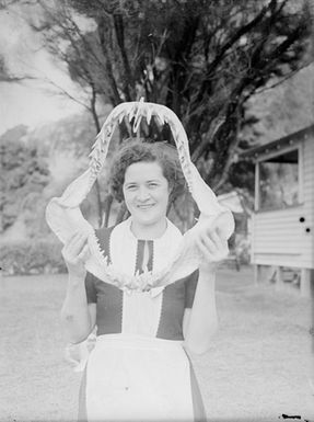 [Portrait of woman holding shark jaw]