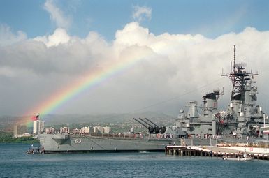 A rainbow highlights the sky in the background as the battleship USS MISSOURI (BB-63) lies tied up at the naval station. The MISSOURI is in Hawaii to take part in the observance of the 50th anniversary of the Japanese attack on Pearl Harbor