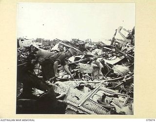 LAE, NEW GUINEA. 1943-10. WRECKED JAPANESE AIRCRAFT AT LAE AIRSTRIP. THE 10TH FIELD AMBULANCE, AUSTRALIAN ARMY MEDICAL CORPS OPERATES IN THE AREA