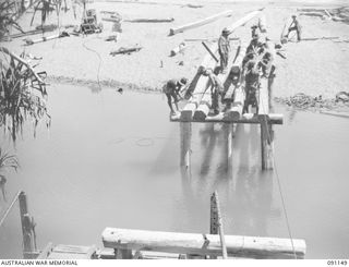 BANAK, AITAPE-WEWAK SECTOR, NEW GUINEA. 1945-04-21. PERSONNEL OF NO.1 PLATOON, 2/1 FIELD COMPANY, ROYAL AUSTRALIAN ENGINEERS, BRIDGING A RIVER IN THE AREA, TO ASSIST SUPPLY LINES TO FORWARD 16 ..