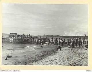 SIPAAI, BOUGAINVILLE ISLAND. 1945-01-07. TROOPS OF THE 31/51ST INFANTRY BATTALION UNLOADING THE UNIT STORES FROM BARGES OF THE 42ND LANDING CRAFT COMPANY AT THE UNIT BEACH-HEAD AT THE MOUTH OF THE ..