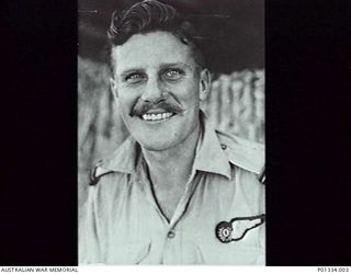 PORT MORESBY, PAPUA. 1943-08. NO 30 BEAUFIGHTER SQUADRON RAAF, WARDS STRIP. FLYING OFFICER GEORGE T. DICK, NAVIGATOR, OF BRISBANE, QLD, OUTSIDE THE SQUADRON OPERATIONS ROOM. (DONOR GEORGE DICK)