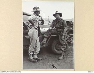 RABAUL, NEW BRITAIN. 1945-11-03. LIEUTENANT W. ROBERTS (1) AND LIEUTENANT A.P. SEALE (2), MEMBERS OF AUSTRALIAN NEW GUINEA ADMINISTRATIVE UNIT, WHO ARE LEAVING RABAUL FOR A SPECIAL CANBERRA SCHOOL ..