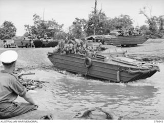 LAE, NEW GUINEA. 1944-11-02. AUSTRALIAN ARMY AMPHIBIOUS LOAD CARRIER (DUKW) LOADED WITH PERSONNEL OF THE 14/32ND INFANTRY BATTALION ENTERING THE WATER ON THEIR WAY OUT TO THE TROOPSHIP, "CAPE ..