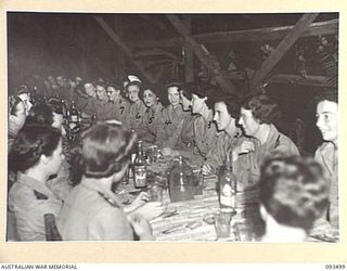 TOROKINA, BOUGAINVILLE. 1945-07-02. A GROUP OF AUSTRALIAN ARMY NURSING SERVICE SISTERS IN THE SISTERS' MESS, 2/1 GENERAL HOSPITAL, DURING A FORMAL DINNER CELEBRATING THE 43RD ANNIVERSARY OF THE ..