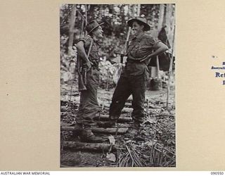WONGINARA MISSION, NEW GUINEA. 1945-04-06. WARRANT OFFICER 2 S.G. DAVISON (1), AND WARRANT OFFICER 1 W.R. EDMONSTON (2), MEMBERS OF 2/3 INFANTRY BATTALION, IN THEIR UNIT AREA