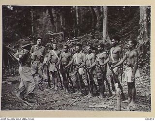 WONGINARA MISSION, NEW GUINEA. 1945-04-06. LIEUTENANT COLONEL I. HUTCHISON, COMMANDING OFFICER, 2/3 INFANTRY BATTALION (1), WITH WARRANT OFFICER 2 JOHN BORRIT GODWIN, AUSTRALIAN NEW GUINEA ..