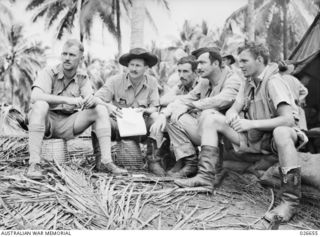 MILNE BAY, PAPUA. 1942-09. FIGHTER PILOTS OF THE RAAF STANDING BY AT THEIR AIRFIELD. LEFT TO RIGHT:- PILOT OFFICER BRUCE BROWN; SQUADRON LEADER L. JACKSON, 75 SQUADRON; FLIGHT LIEUTENANT V. ..