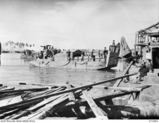 MADANG, NEW GUINEA. 1944-04-24. TROOPS OF THE 8TH INFANTRY BRIGADE ABOARD THE LCM (LANDING CRAFT MECHANIZED) M9C25 WHICH IS ABOUT TO BERTH AFTER COMPLETING THE TRIP FROM SAIDOR