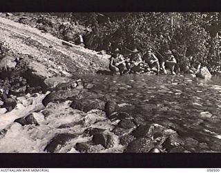 REINHOLD HIGHWAY, NEW GUINEA, 1943-08-31. WORKING PARTY OF THE 2/4TH AUSTRALIAN FIELD SQUADRON, ROYAL AUSTRALIAN ENGINEERS, RELAXING AT A SMALL FORD AT THE 22 1/4 MILE POINT. LEFT TO RIGHT: VX56214 ..