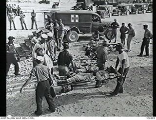 PELELIU, PACIFIC OCEAN. 1945-07. INJURED SURVIVORS OF THE CRUISER USS INDIANAPOLIS ON STRETCHERS ARE LOADED INTO AMBULANCES FOR TRANSPORT TO HOSPITAL. THE INDIANAPOLIS WAS SUNK BY A JAPANESE ..