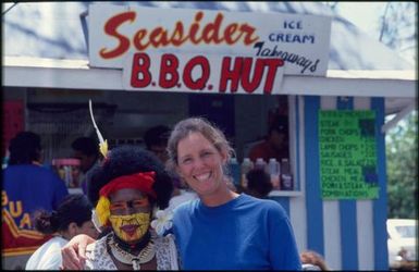 Performer from Papua New Guinea with tourist, Sixth Festival of Pacific Arts