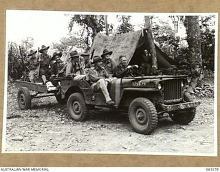 RAMU VALLEY, NEW GUINEA. 1944-01-01. MEMBERS OF THE 7TH DIVISION CONCERT PARTY IN THEIR JEEP AND TRAILER