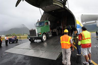 Earthquake ^ Flooding ^ Tsunami - Pago Pago, American Samoa, October 13, 2009 -- A diesel tractor backs up into the Antonov AN-225 cargo plane to unload generators. The cargo plane is the world's largest fixed wing aircraft and it carried generators contracted by the Federal Emergency Management Agency to assist the island with electrical power restoration. David Gonzalez/FEMA