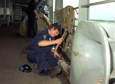 Engineman Fireman Apprentice (ENFA) Michelle L. Smith disconnects the shore based power line as the submarine tender USS HOLLAND (AS-32) completes preparation for getting underway for a 45 day cruise which will include a stop over in Sasebo, Japan