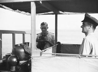 AT SEA, OFF BUIN, BOUGAINVILLE, 1945-08-20. THE BRIDGE OF THE CORVETTE HMAS LITHGOW SHOWING PETTY OFFICER L.C. MOORE, COXSWAIN (1), AND LIEUTENANT G.S.H. CHAMPION, CAPTAIN (2), ON THE OCCASION OF ..