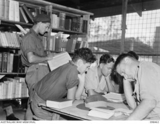 TOROKINA, BOUGAINVILLE, 1945-10-27. STUDENTS AT THE TOROKINA REHABILITATION TRAINING CENTRE USING THE REFERENCE LIBRARY WHICH IS SUPPLEMENTED BY A TECHNICAL LIBRARY. IDENTIFIED PERSONNEL ARE: ..