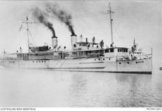 Probably New Guinea. c.1943. Starboard side view of the stores carrier and depot ship HMAS Koopa