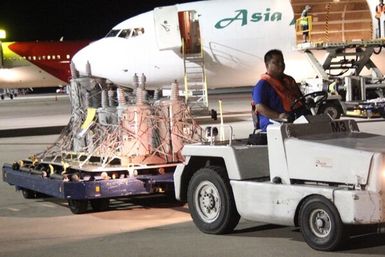 Saipan Airport employee offloading transformers from a lane. These transformers were delivered to aid in the efforts to restore long-term power to Saipan after Typhoon Soudelor caused serious damage back in August, 2015. A total of 486 transformers will be delivered to Saipan by the end of the month.