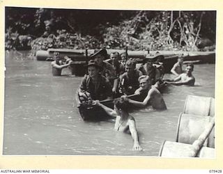 MEVELO RIVER, HENRY REID BAY, NEW BRITAIN. 5 MARCH 1945. TROOPS OF C COMPANY, 14/32ND INFANTRY BATTALION BEING FERRIED ACROSS THE RIVER BY MEANS OF ASSAULT BOATS