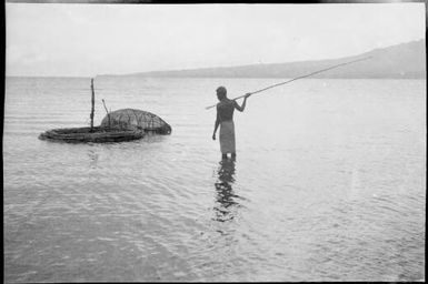 Fishing basket and a man holding a spear, New Guinea, ca. 1929 / Sarah Chinnery