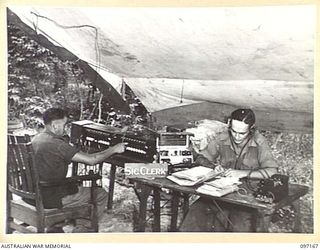 SIGNALMAN H.V. LAMBERT (1), OPERATING A DOUBLE 10-LINE SWITCHBOARD, AND LANCE CORPORAL J.L. WILSON, THE SIGNAL CLERK (2), AT 4TH INFANTRY BRIGADE SIGNAL SECTION